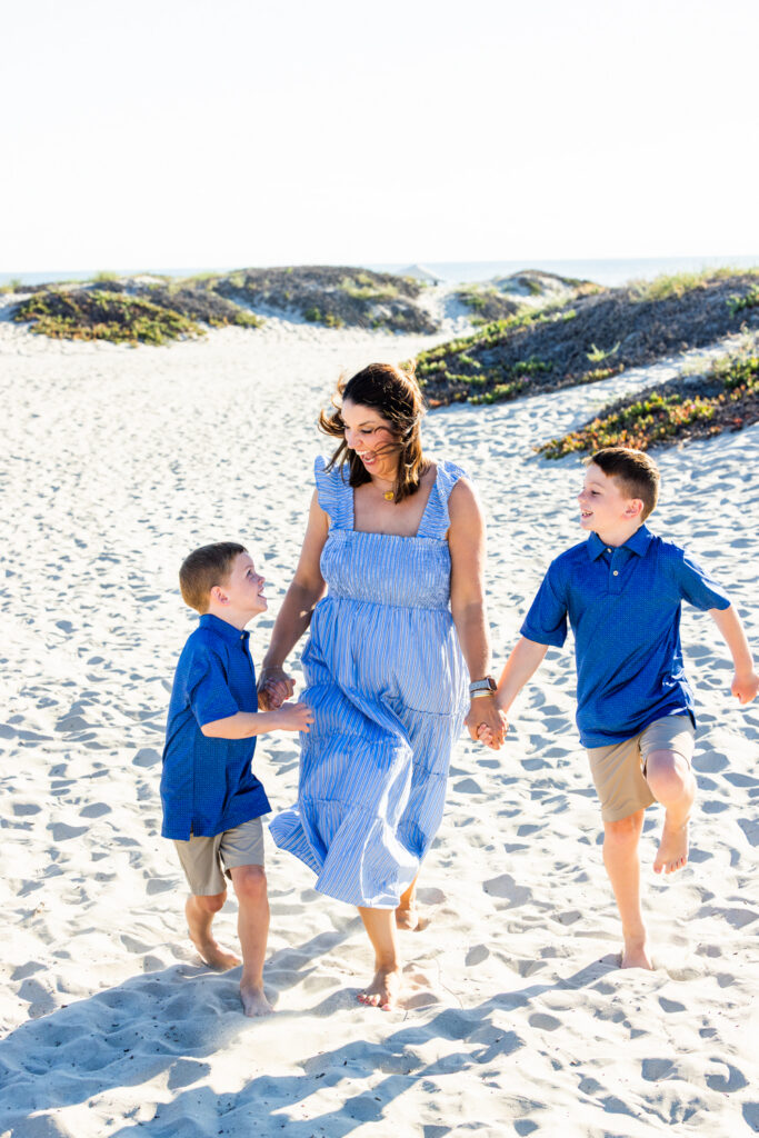 A Windy Evening with a Lifestyle Photographer San Diego Families Trust Relaxed family portrait capturing special vacation memories on Coronado Beach
